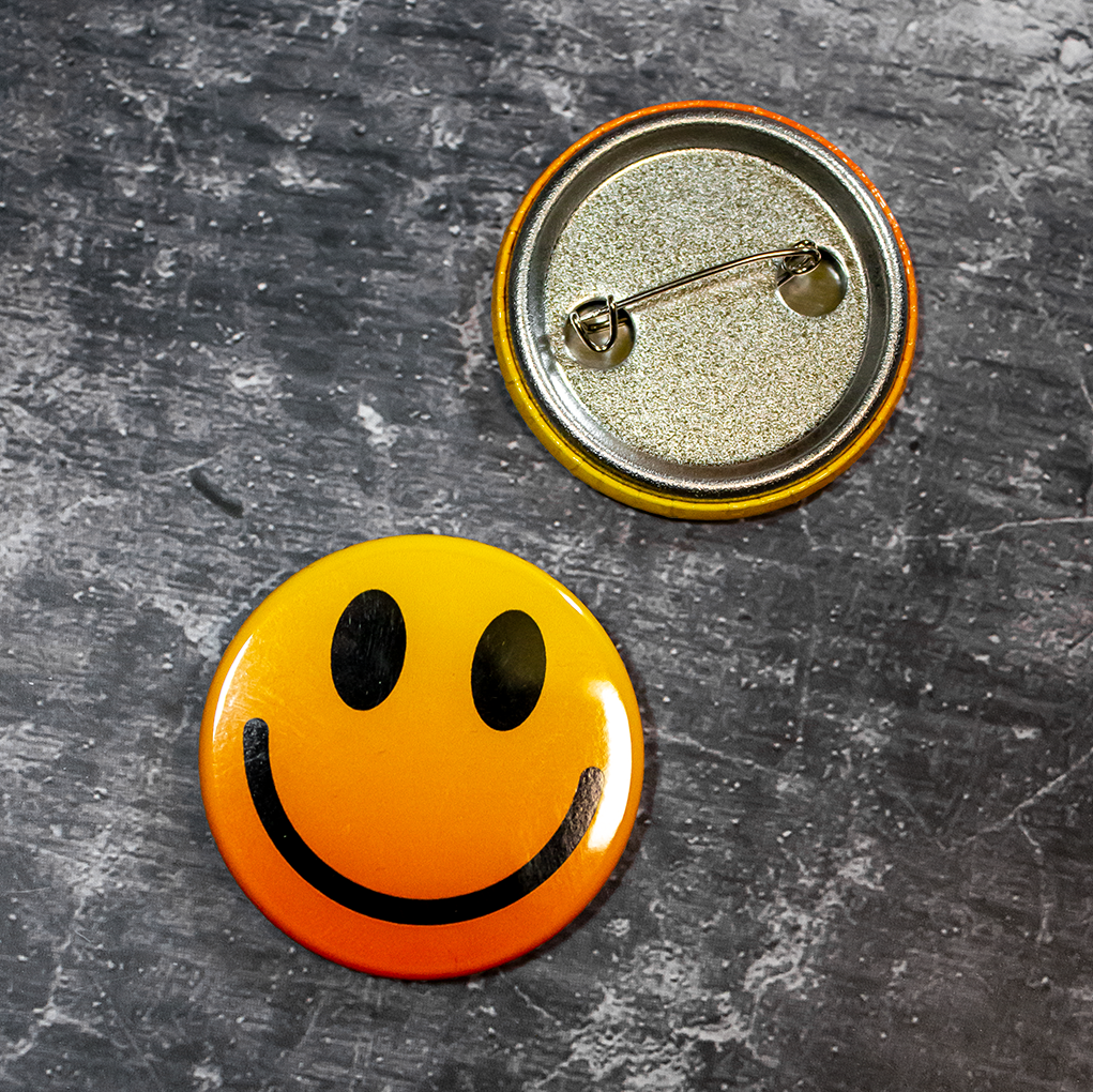 10 custom gloss pin badges with orange and yellow smiley face