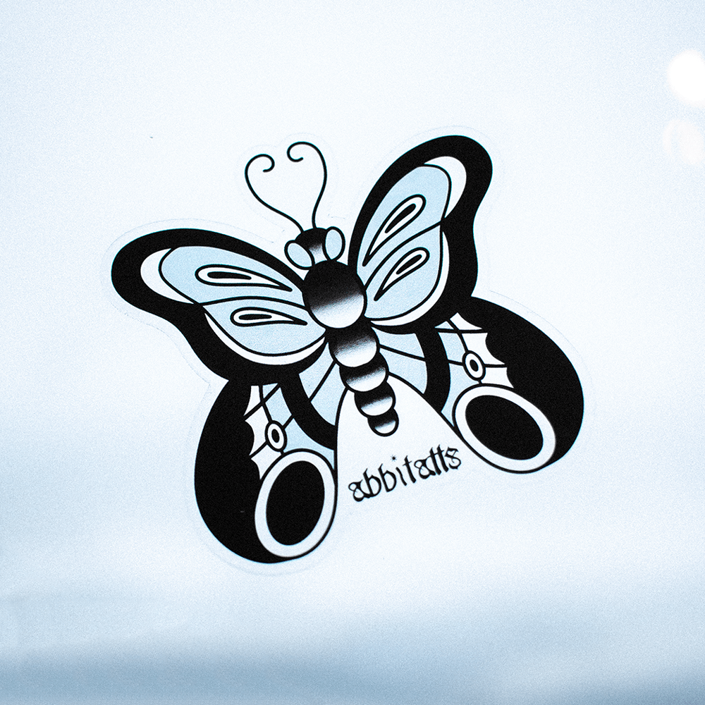 DeadGood transparent vinyl butterfly sticker applied to a smooth surface, showing clear background
