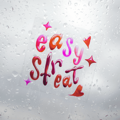 Transparent vinyl sticker with colorful Easy Street lettering design applied to glass with water droplets, showing clear background effect