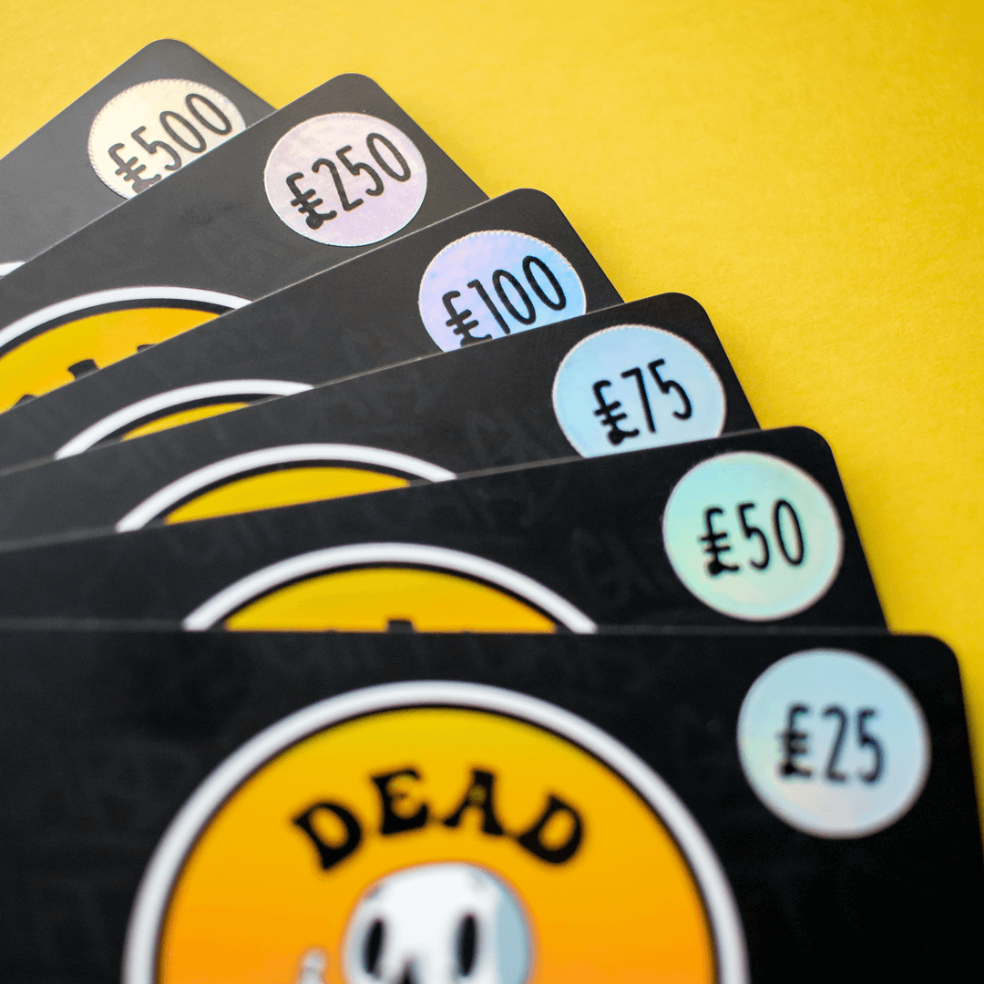 Black gift cards with various amounts in pounds on a yellow background, featuring a 'DEADGOOD' logo.